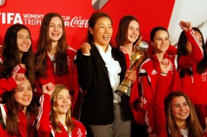 Ottawa, April 1, 2015: Nepean Hotspurs players with Nozomi Yamago of Japan, current FIFA World Cup winner, on first leg of the FIFA Women's World Cup trophy tour. Photo credit: Joe Lofaro