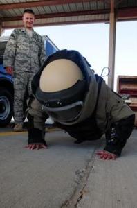 Leanne Hardin does pushups dressed in a bomb suit during an open house at an air base in Southwest Asia. (U.S. Air Force photo by Staff Sgt. Lakisha A. Croley/Released)